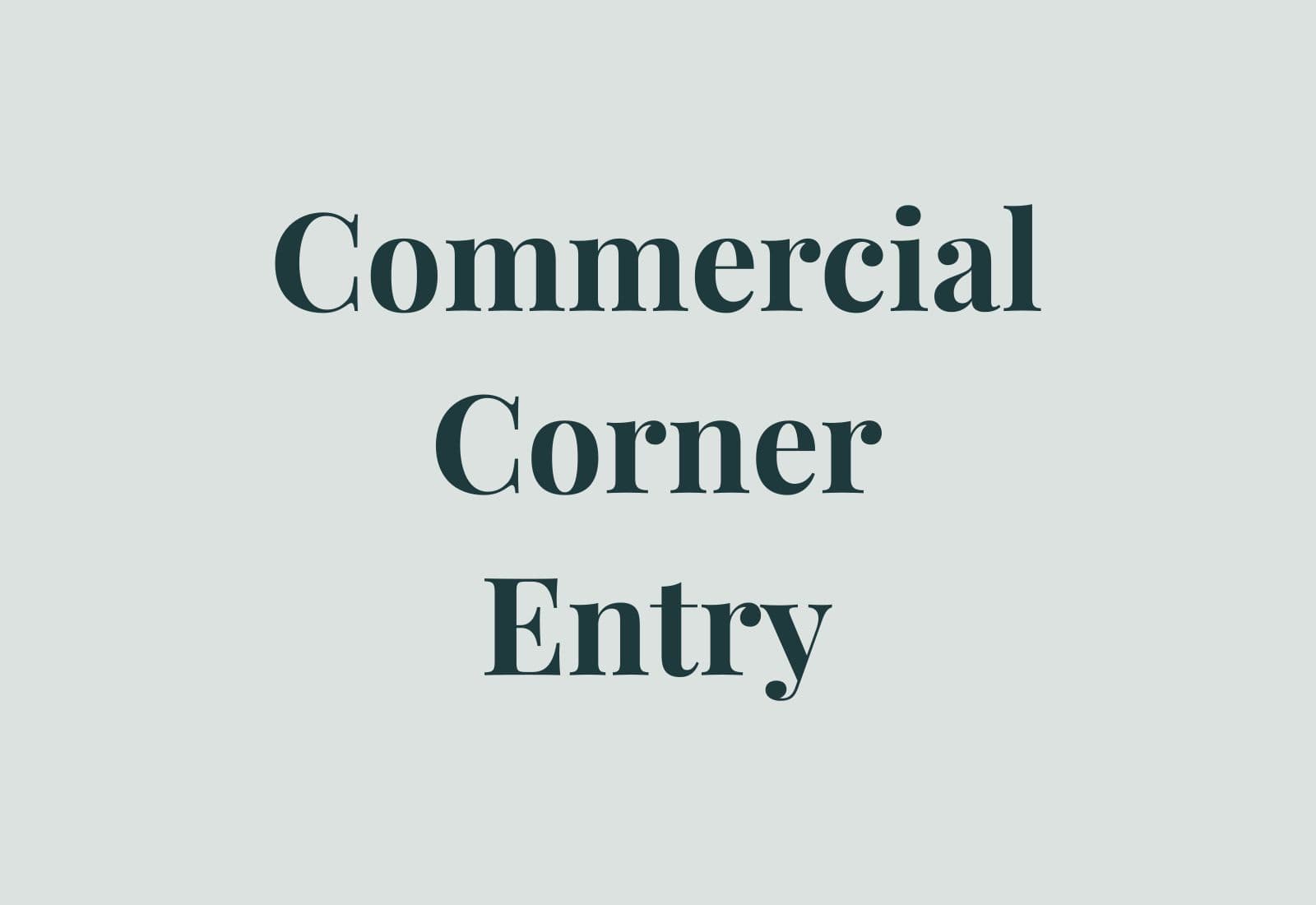 Commercial building corner entry with strong signage zone, glazing, and durable architectural materials.
